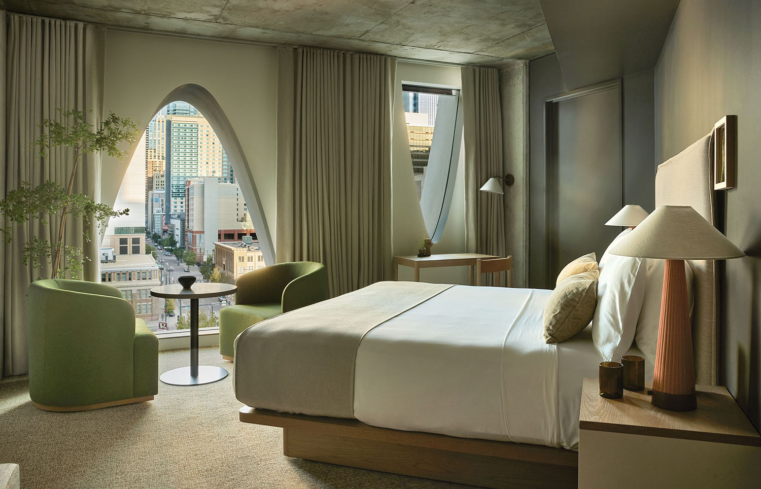 A hotel room with a bed and a chair.