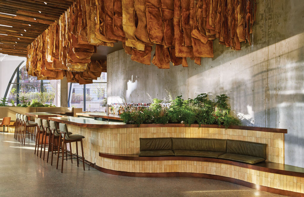 A restaurant with a bunch of meat hanging from the ceiling.