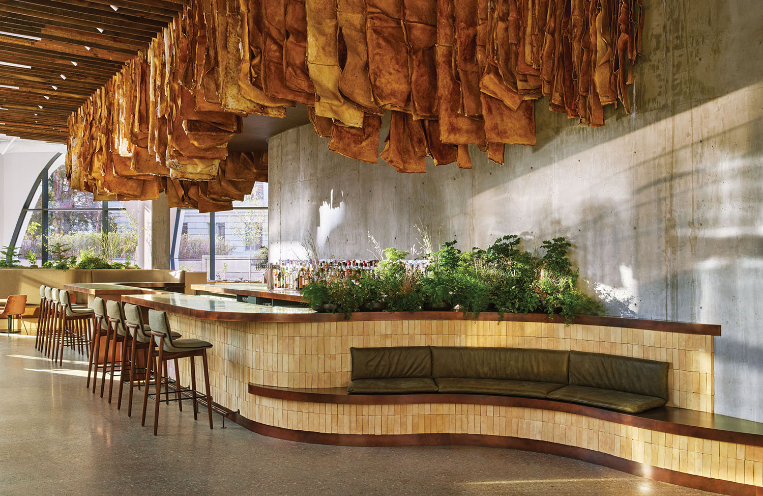 A restaurant with a bunch of meat hanging from the ceiling.