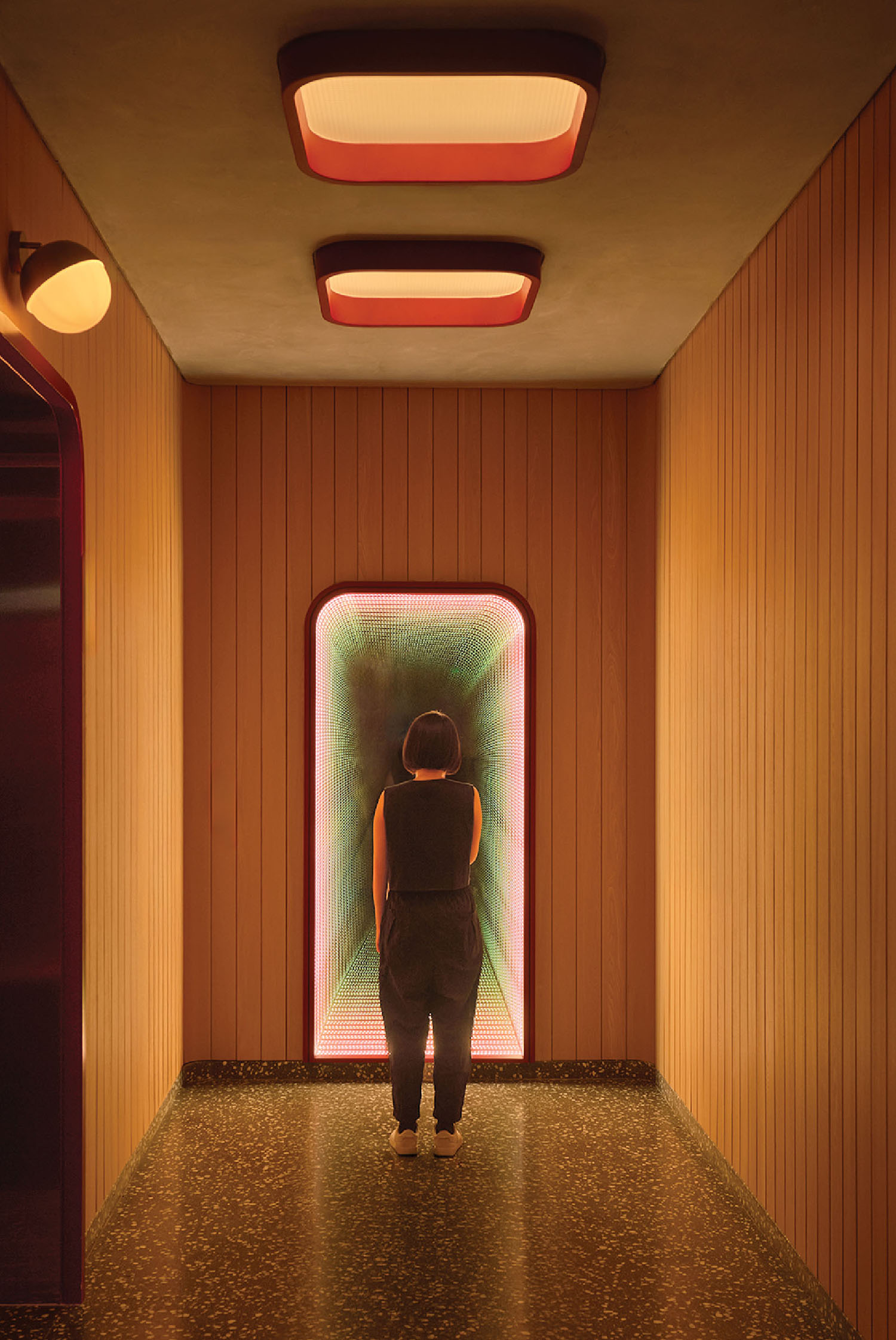 A person walking down a long hallway.