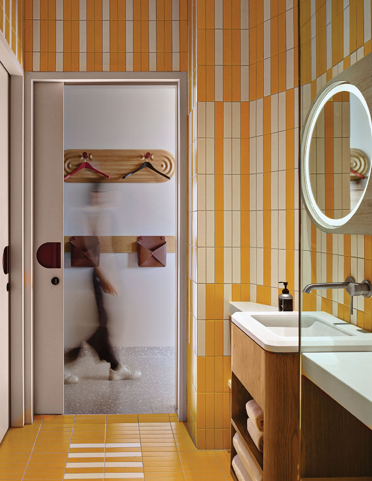 A bathroom with a mirror and a sink.