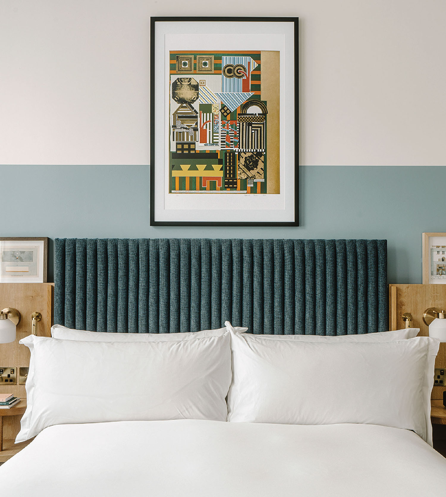 A bed with a white comforter.
