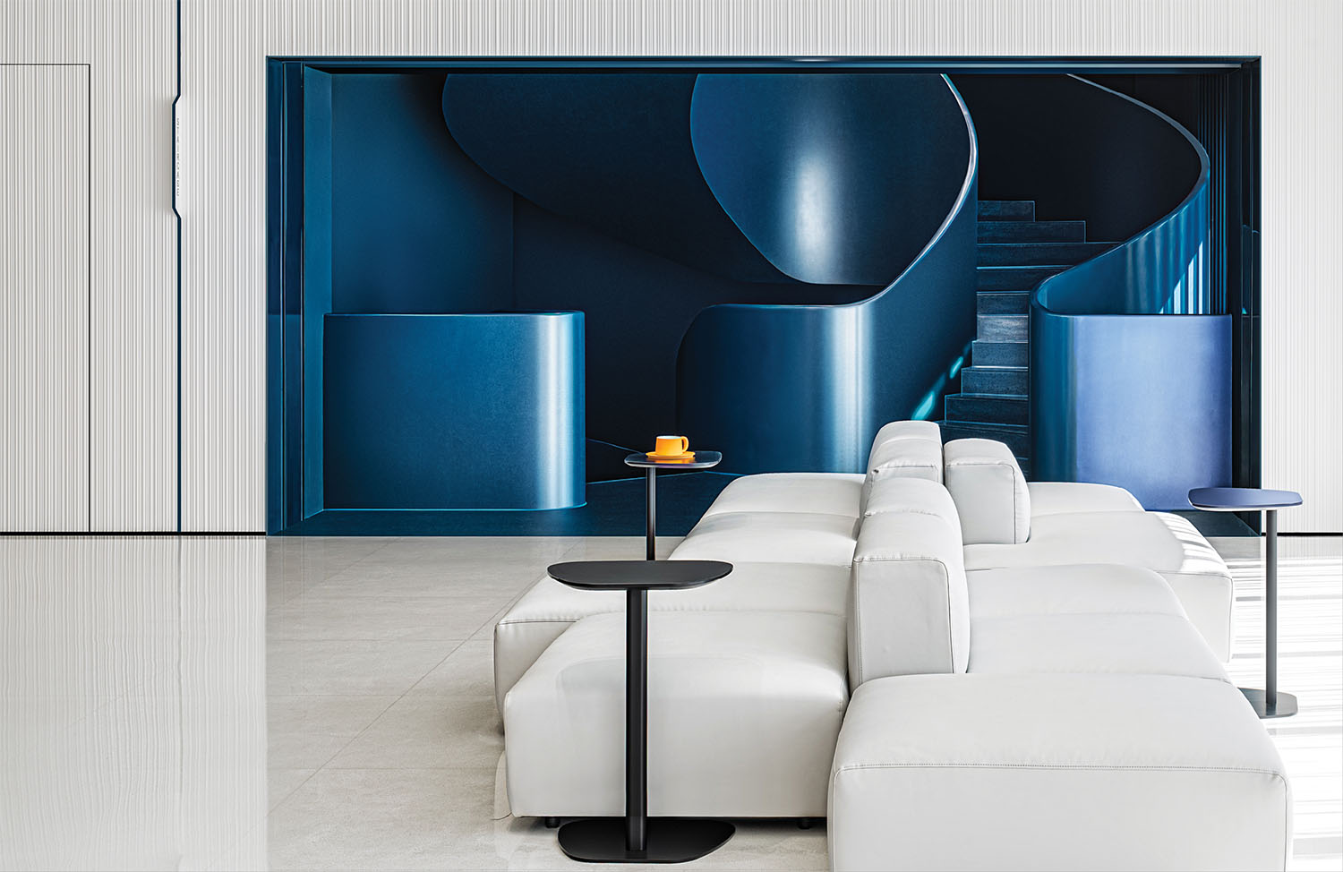 A white couch sitting in front of a blue wall.