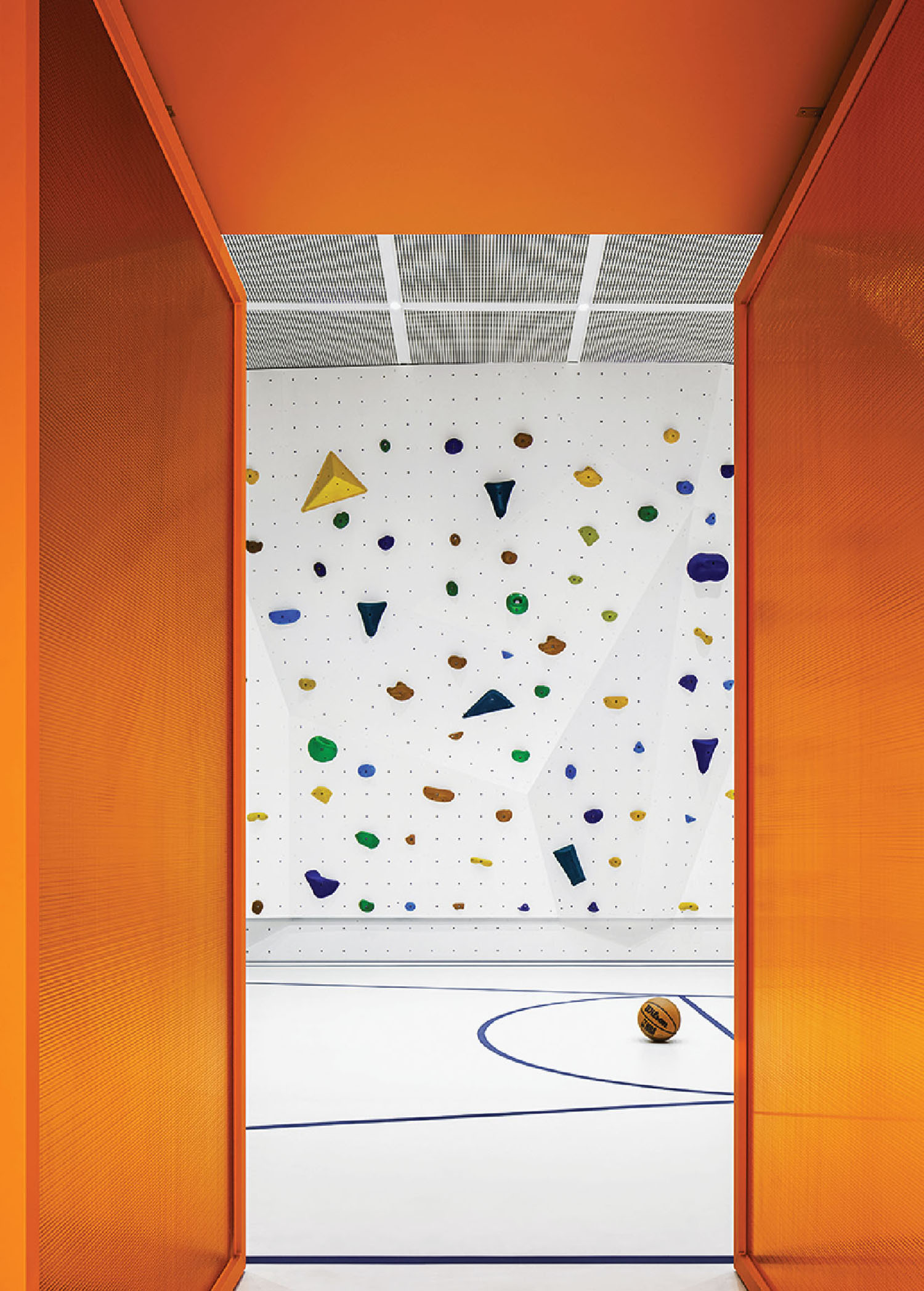 A climbing wall with a climbing ball in the middle.