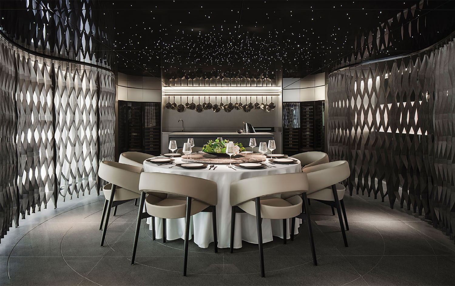 A dining room with a round table and chairs.
