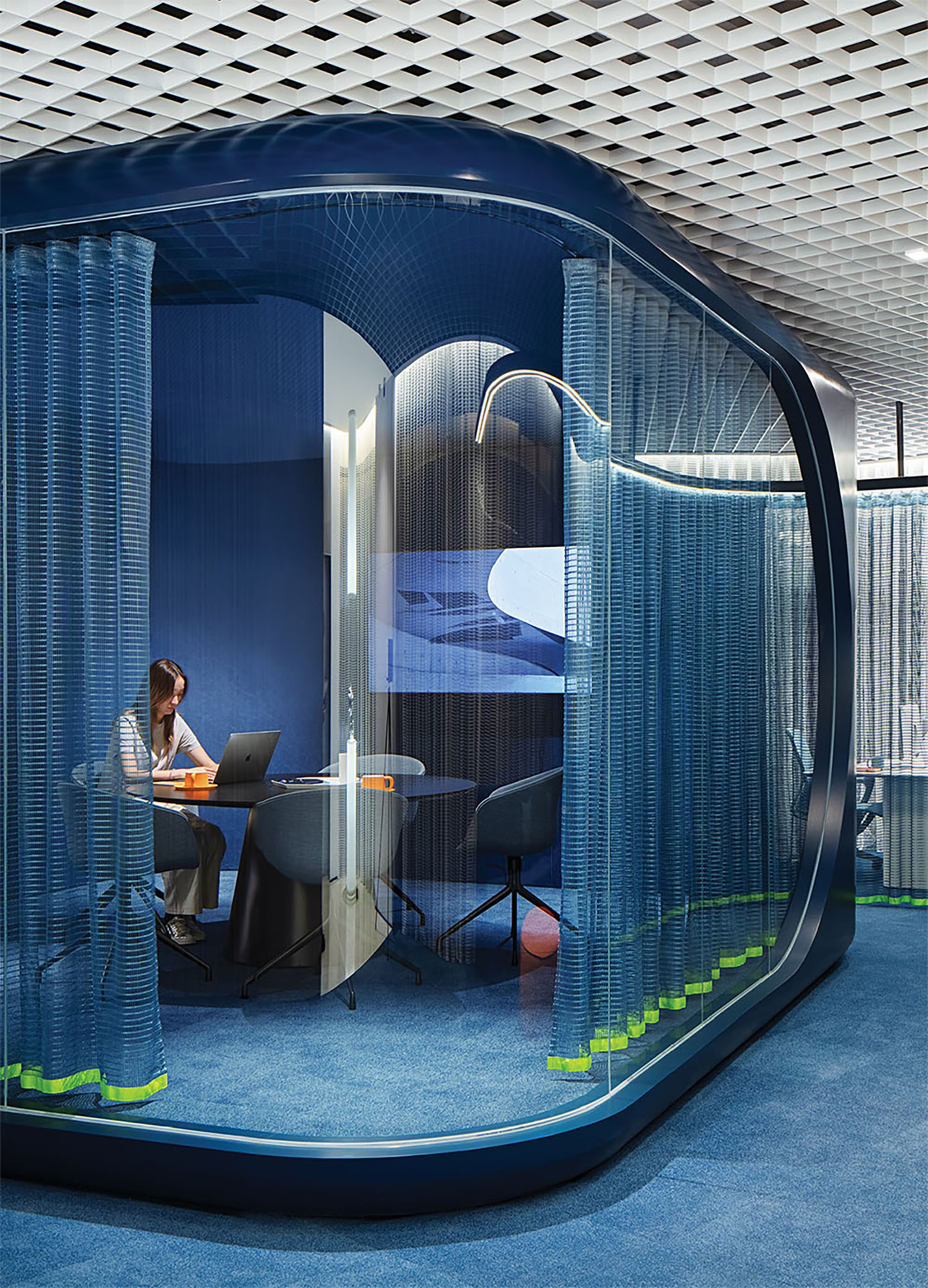 A woman sitting at a desk in a room.