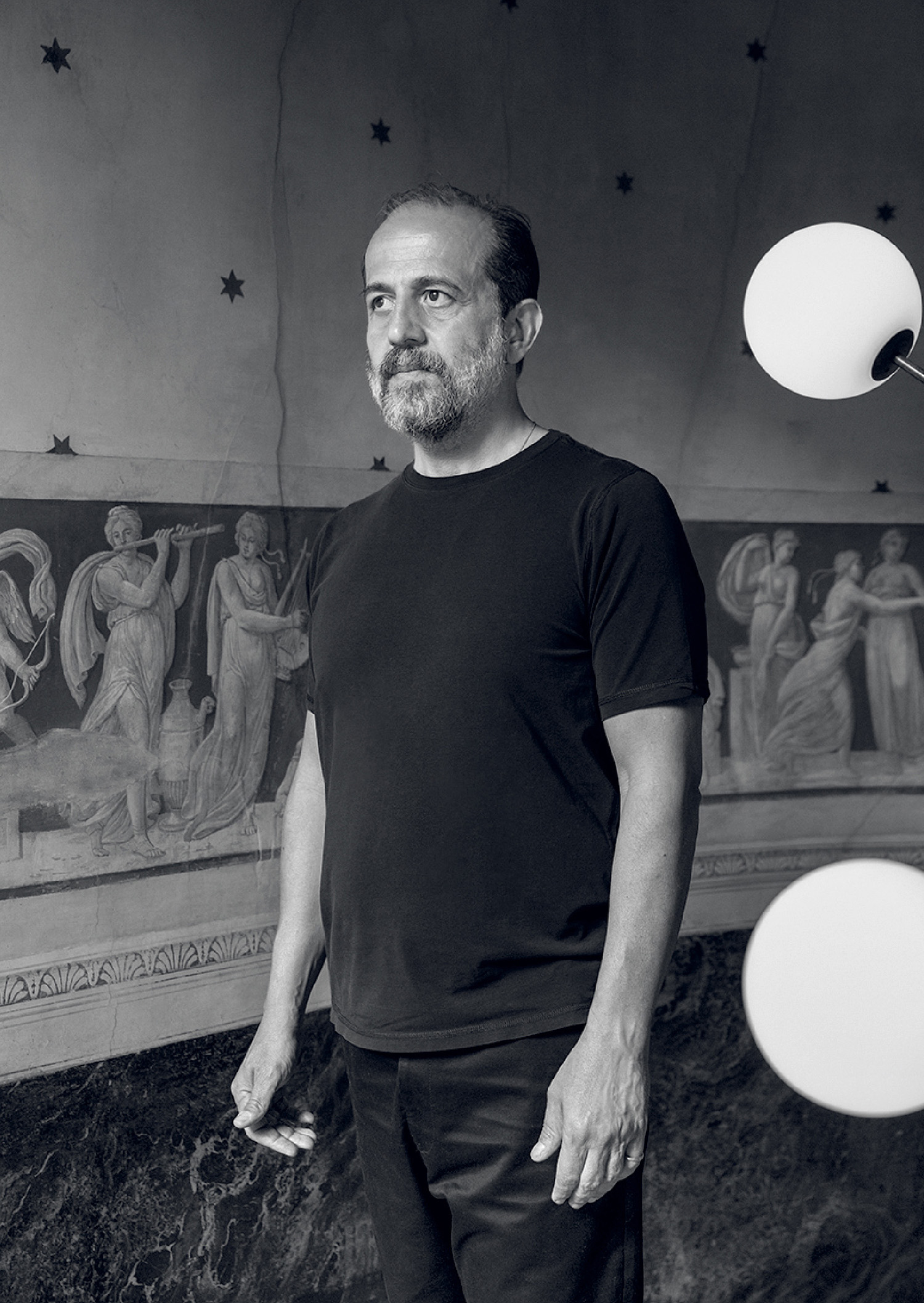 A man standing in front of a mural.