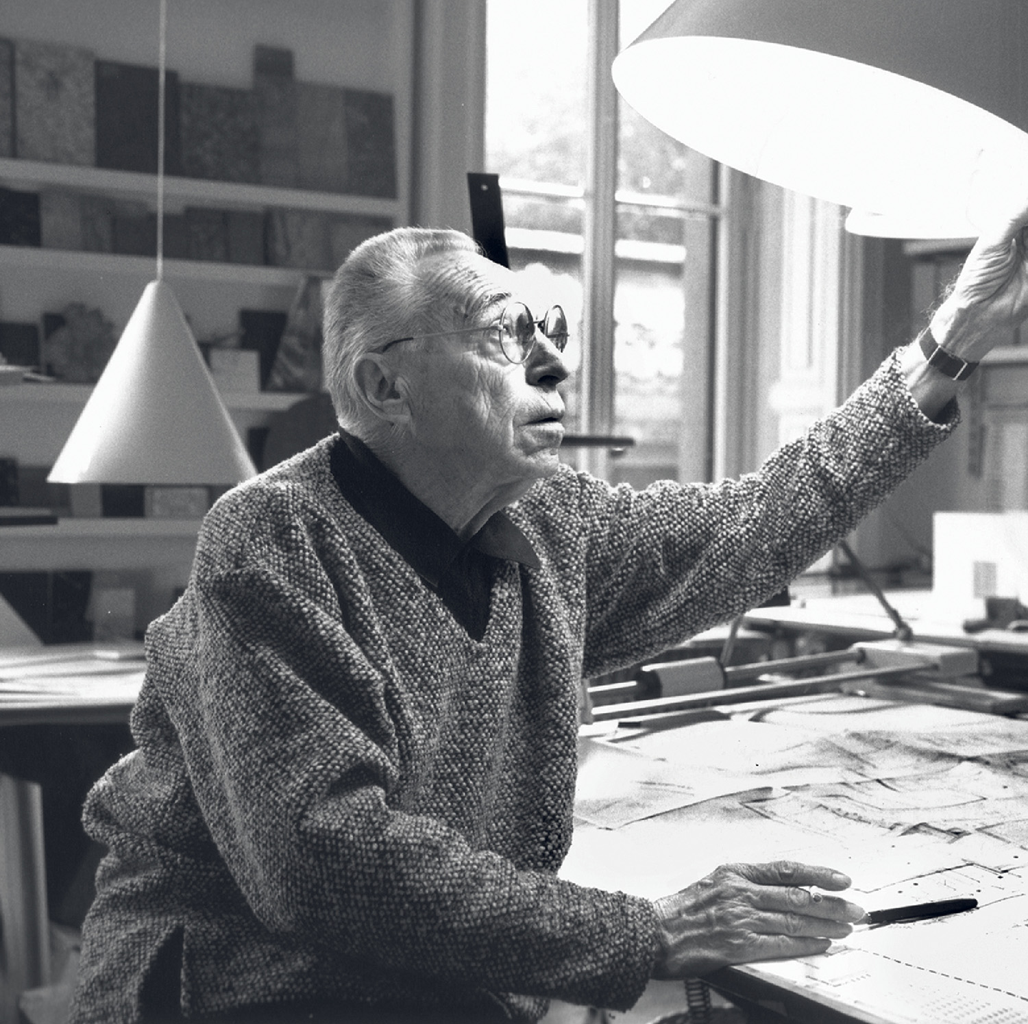 A man sitting at a desk with a paper airplane
