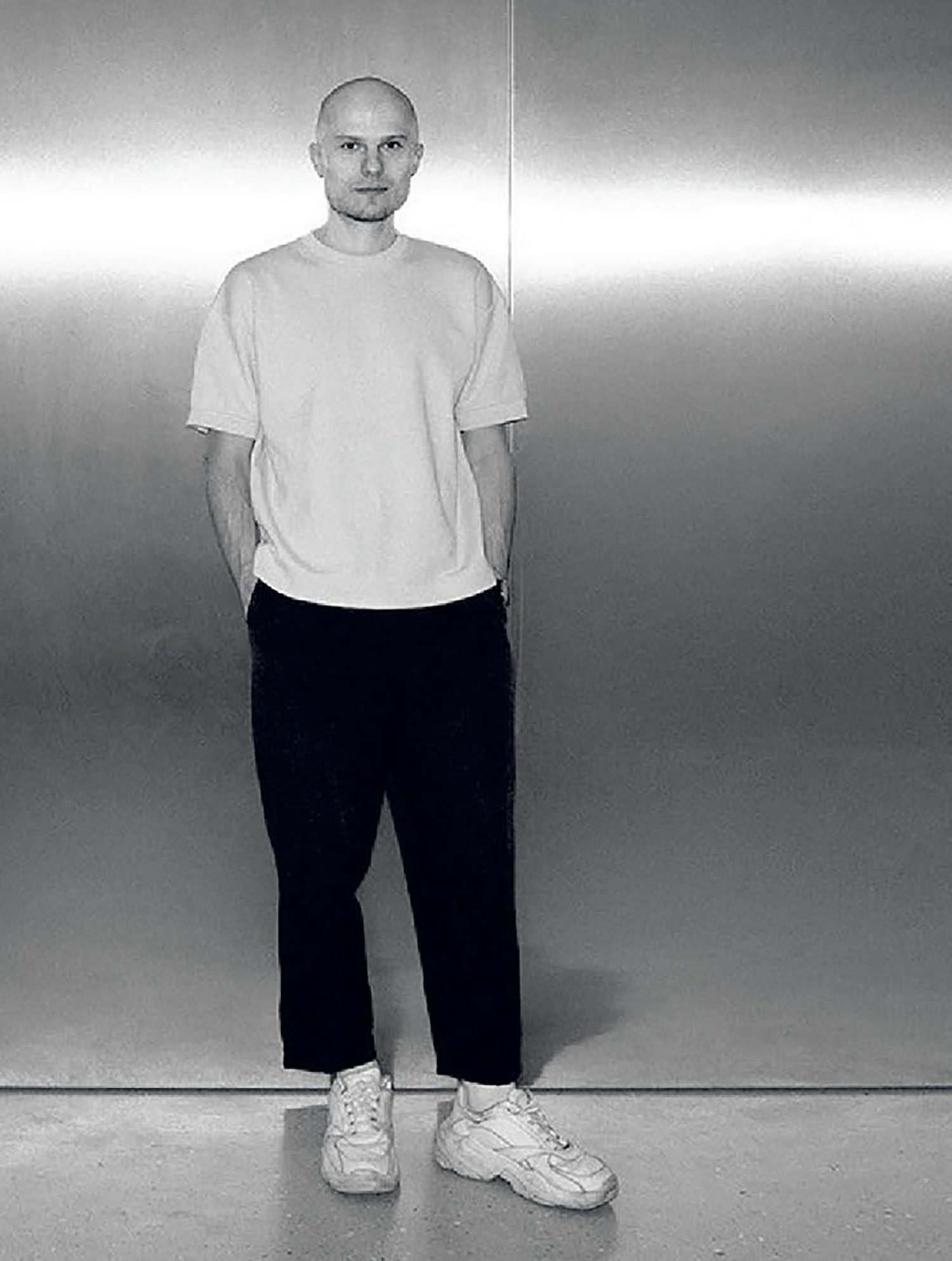 A man standing in front of a wall.