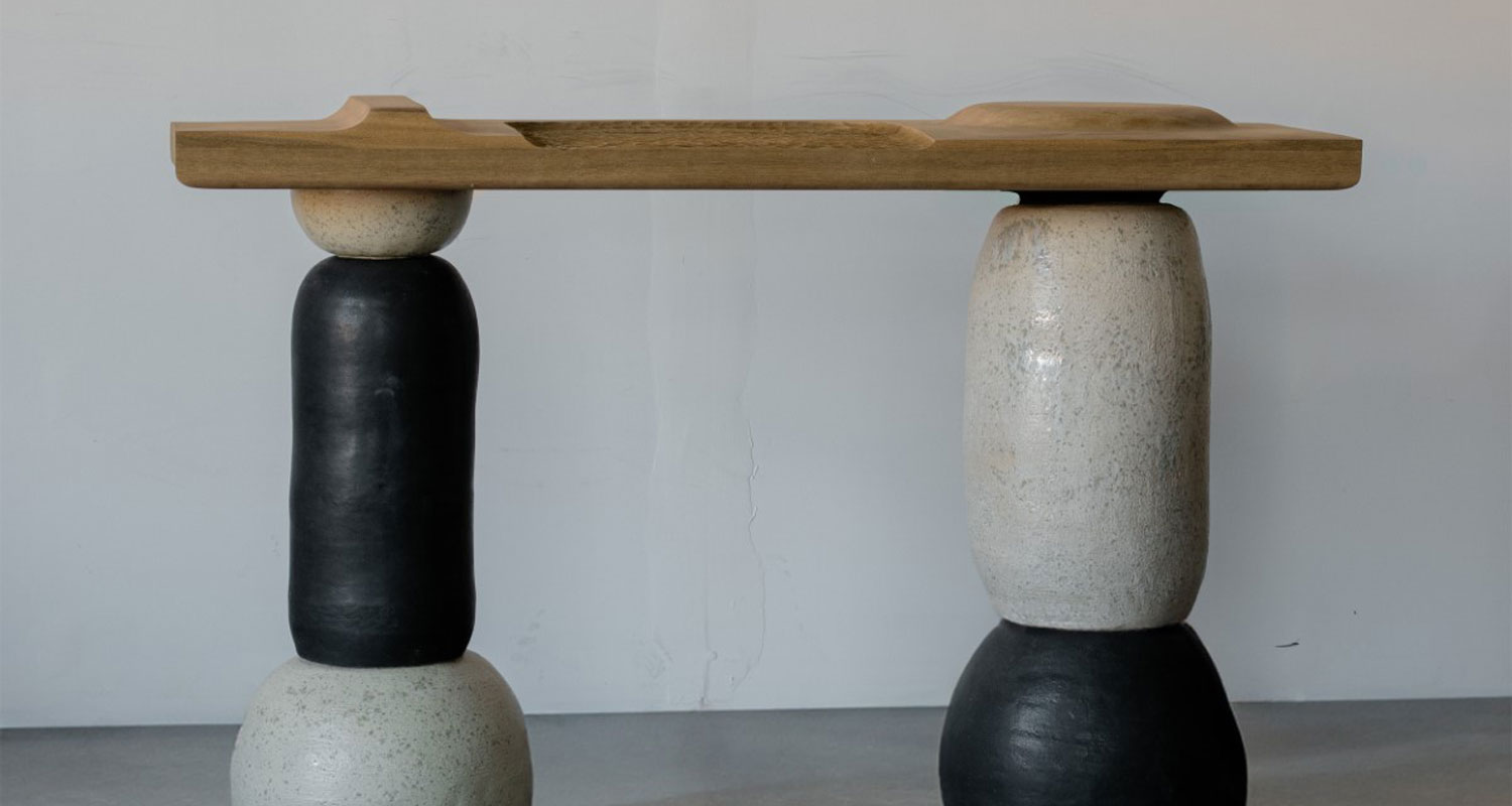 a ceramic table base with a wood top