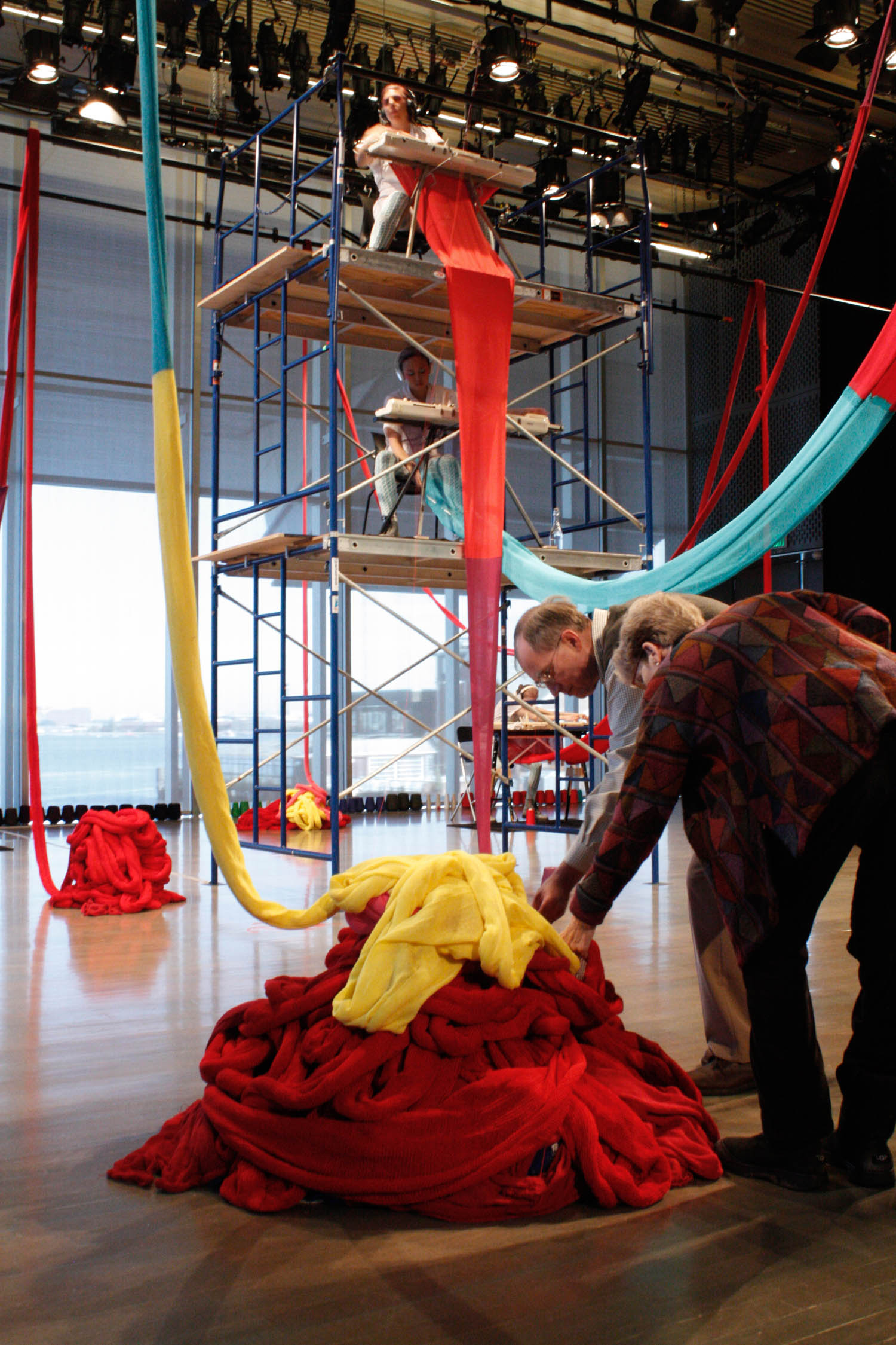 person putting different colored scarves together