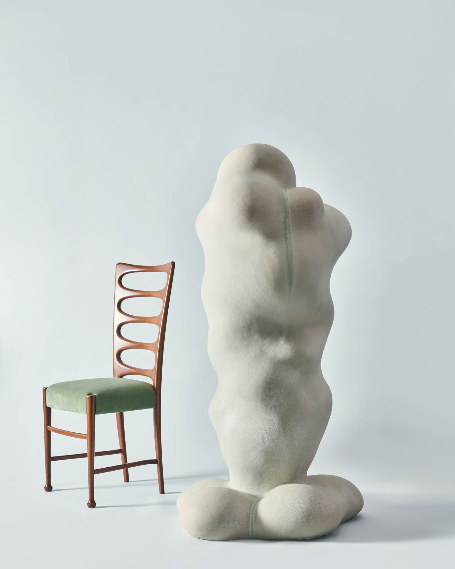white sculpture next to chair