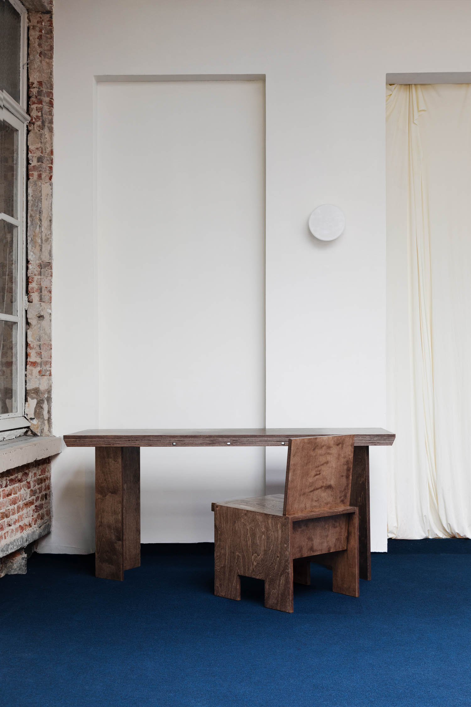 corner of room with wooden table and chair