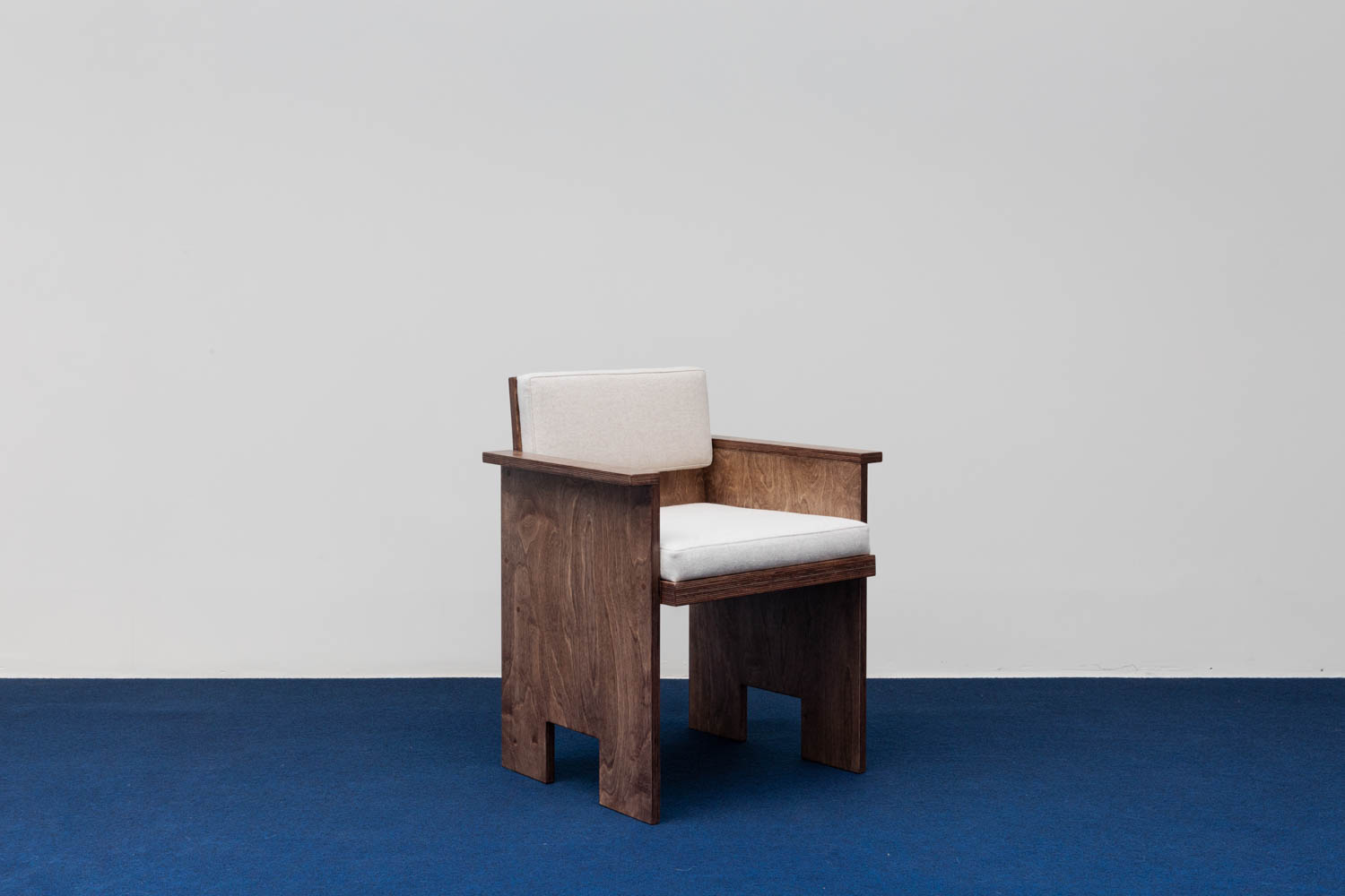 wooden chair on blue carpet