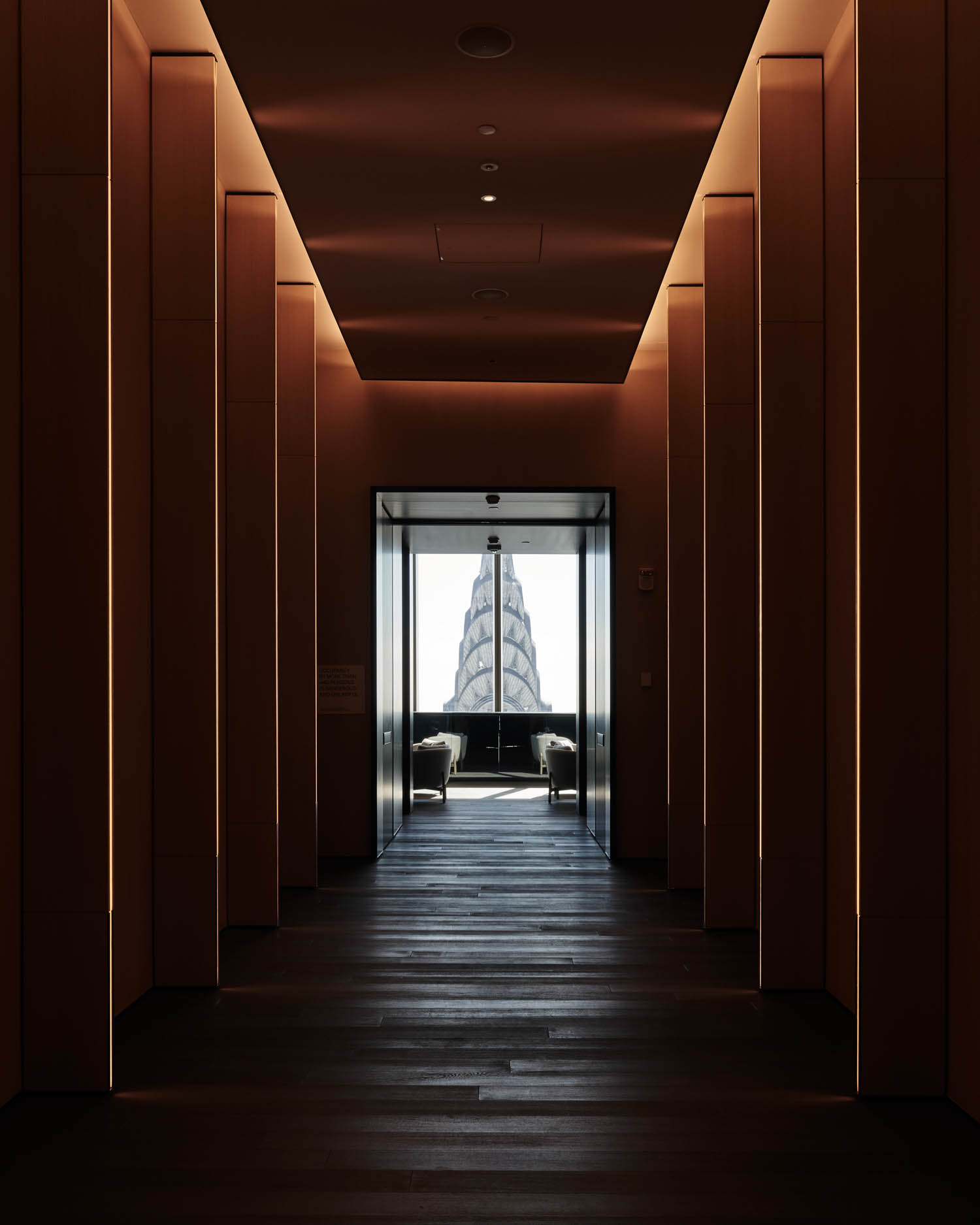 dark lounge with lit hallways