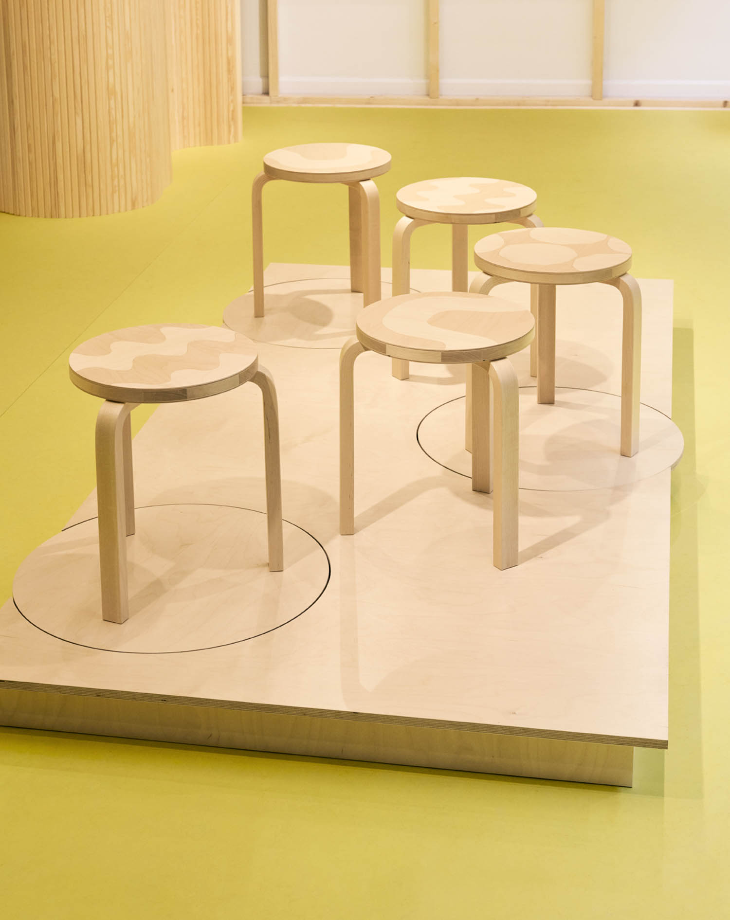 multiple stools on a wooden platform