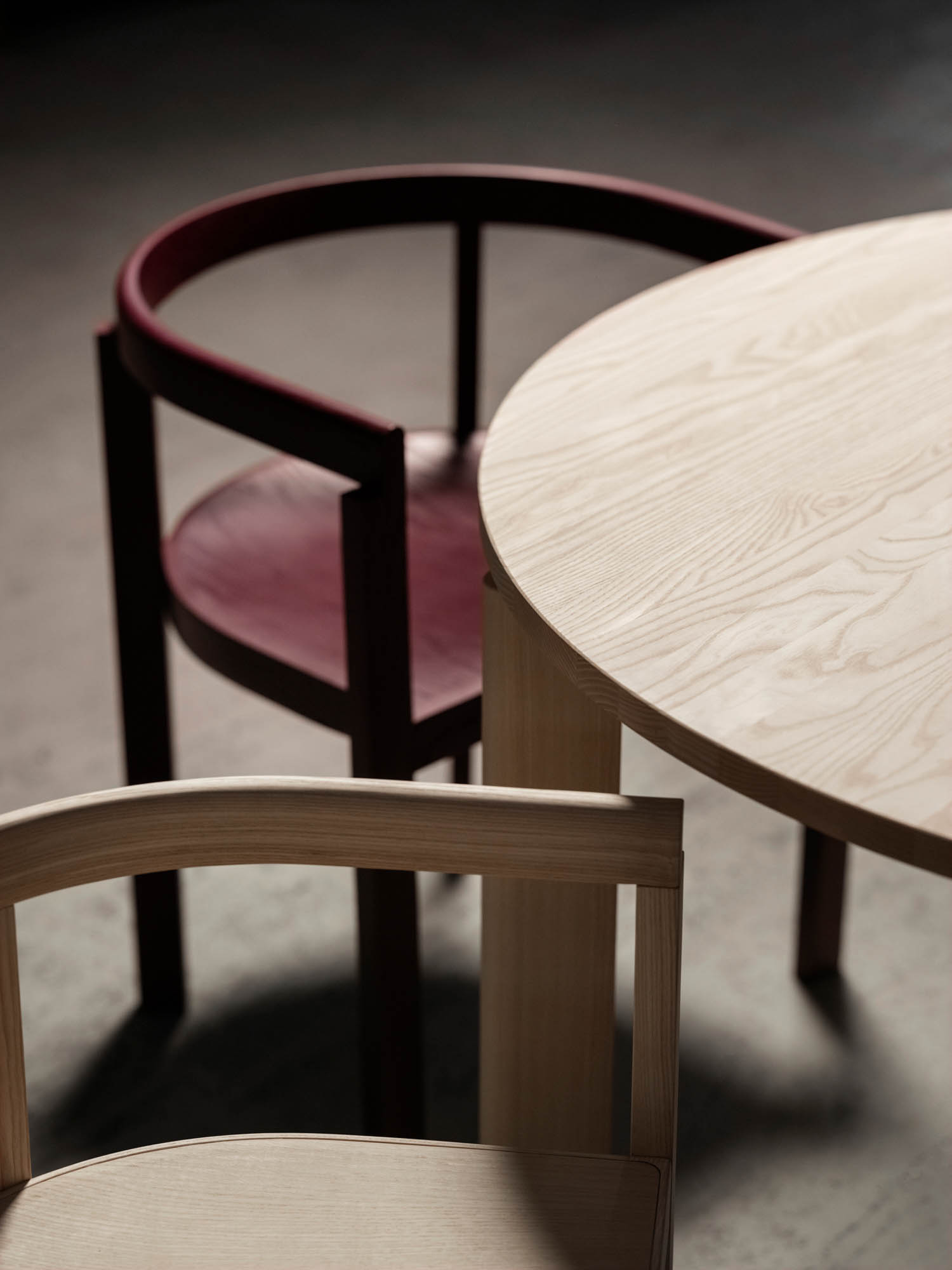 red chair next to a wooden table