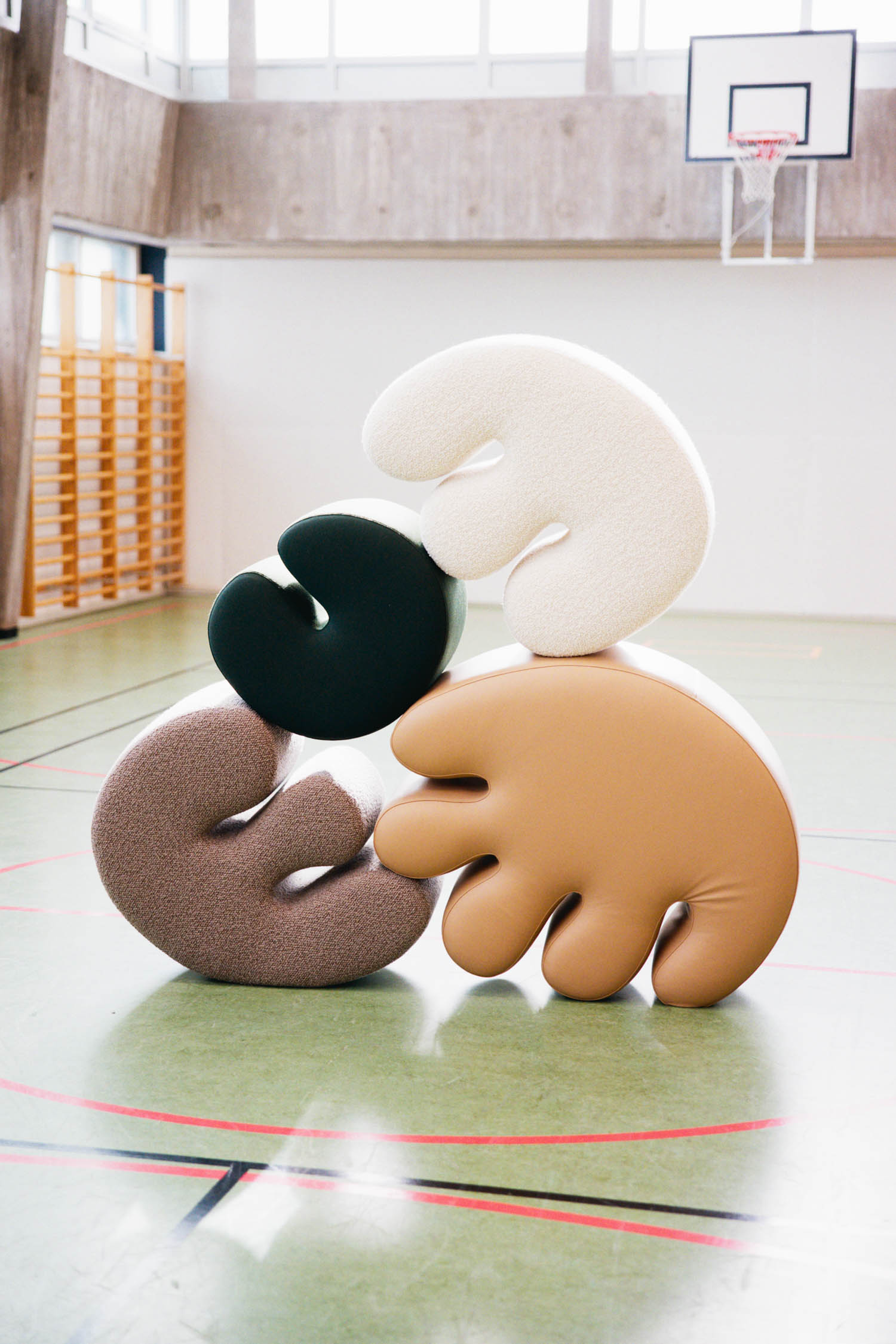 multiple sculptural poufs stacked up