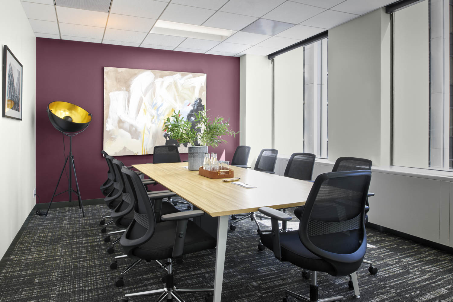 conference room with long table, artwork and purple wall
