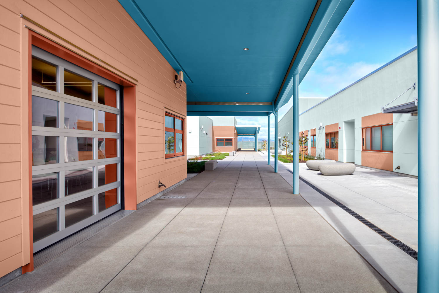 outdoor hallway with peach walls and blue sunroof