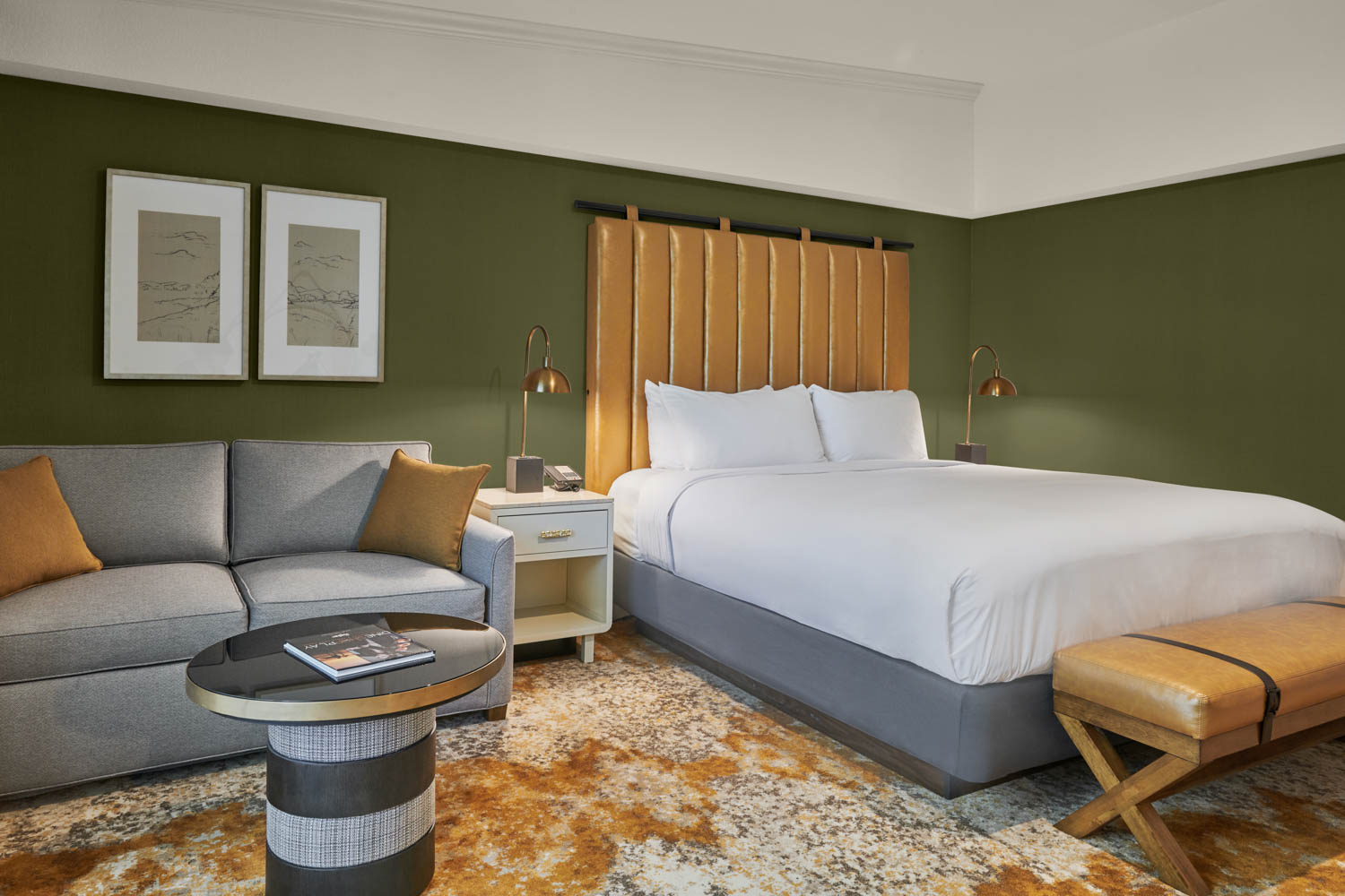 bedroom with sage green walls and grey couch