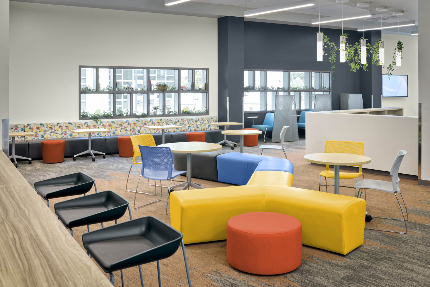 sitting area with colorful stools and tables