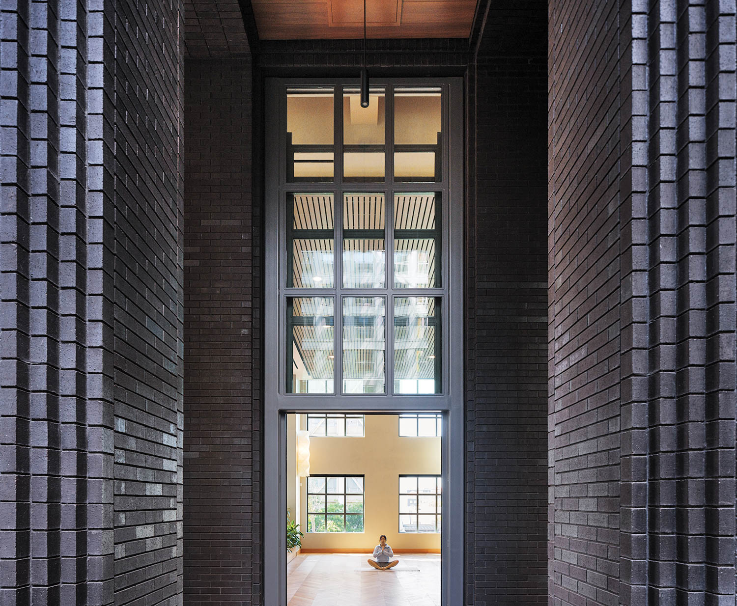 long hallway with dark blue tiles