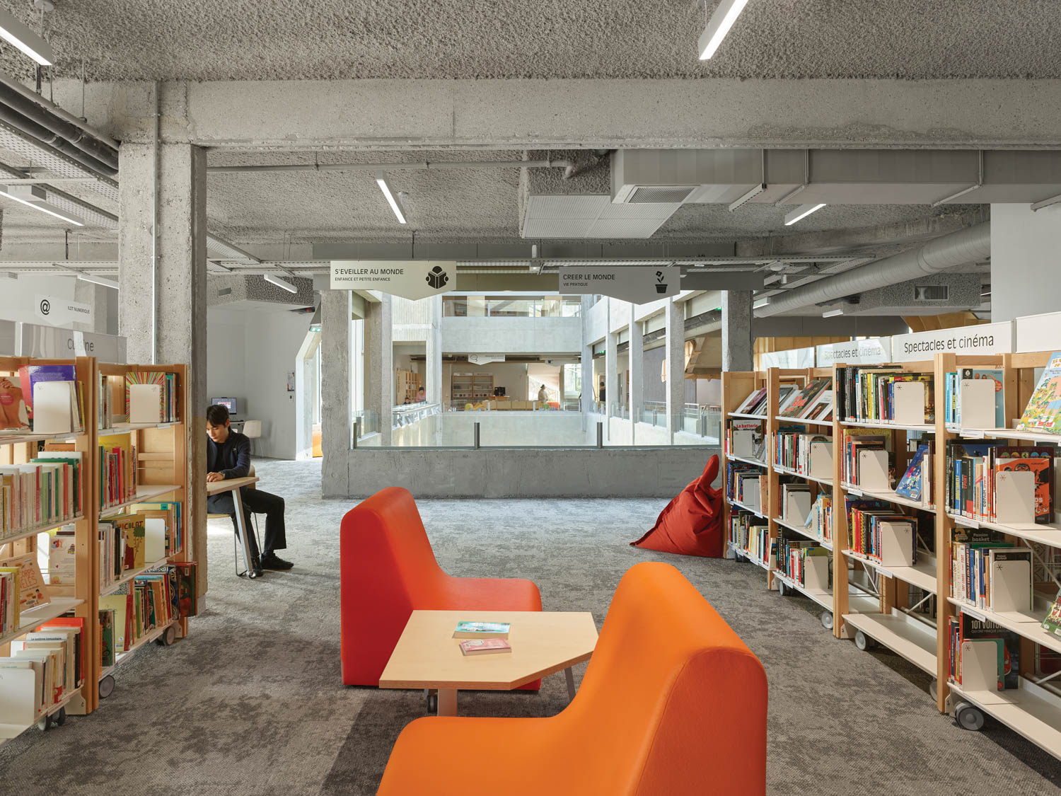 library with bright orange chairs and shelves