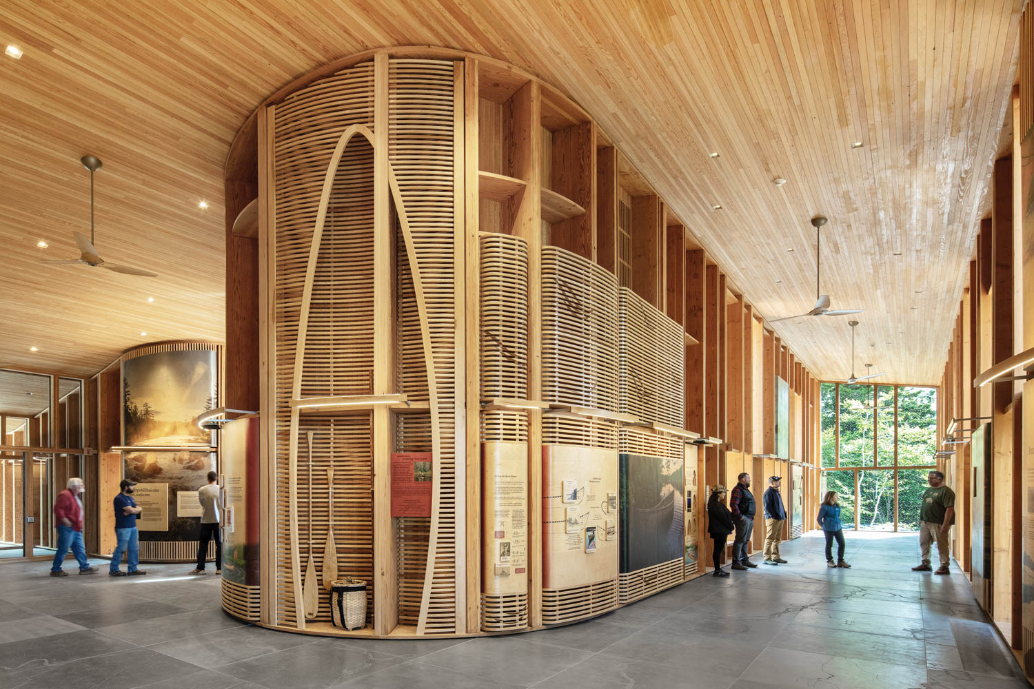 museum area with tall shelves and displays made of mass timber