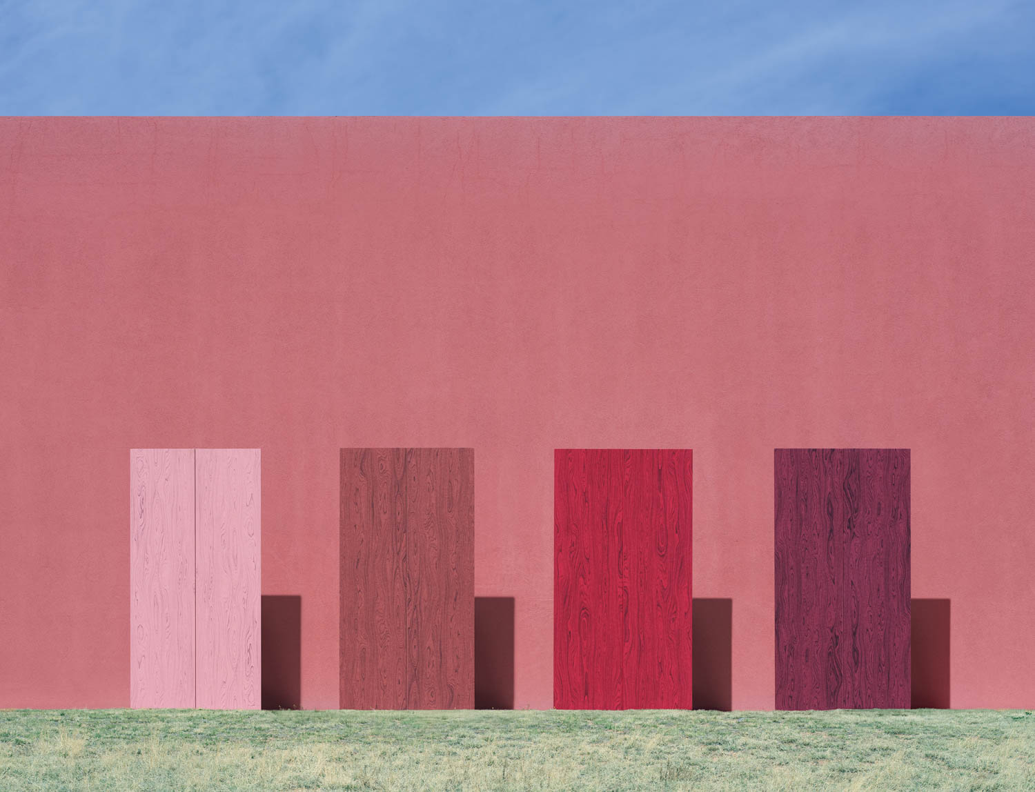 multiple wood blocks in front of red wall