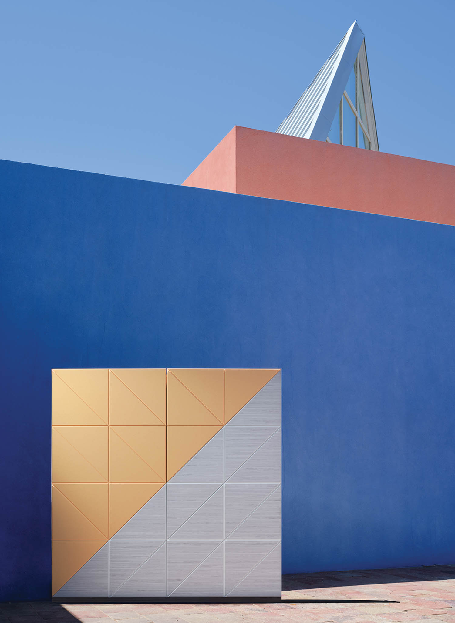 yellow and silver block in front of blue wall