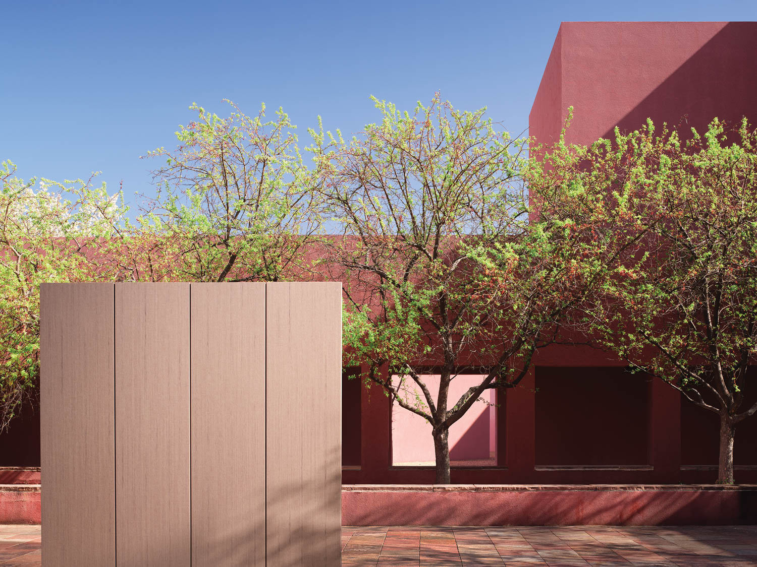 tan block in courtyard in front of trees