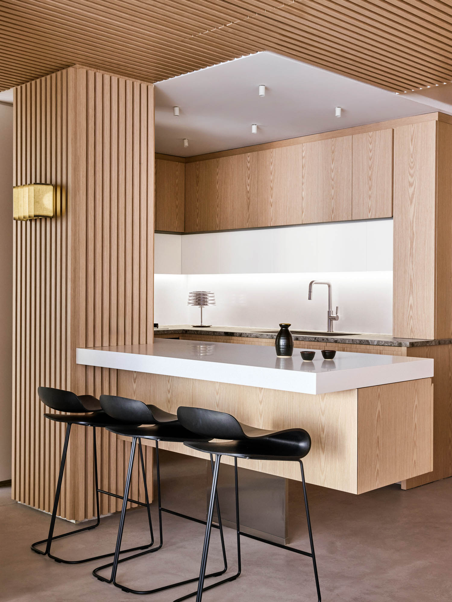 kitchen with wooden slatted columns and floating island