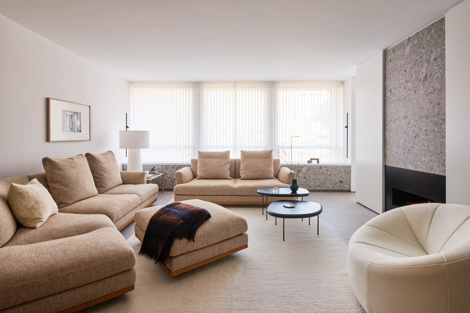 living room with neutral furnishings and stone fireplace