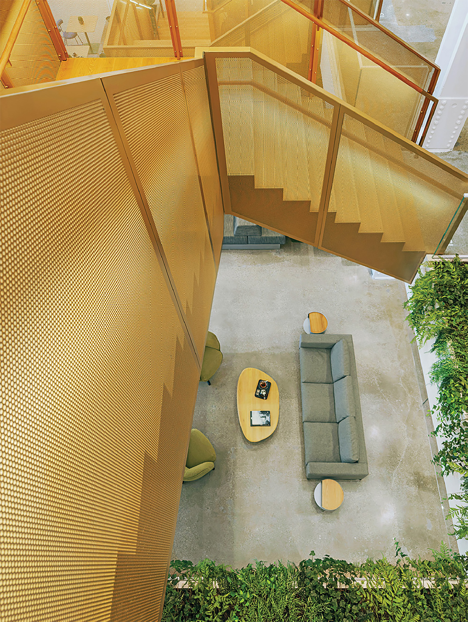 A living room with a couch and a staircase.