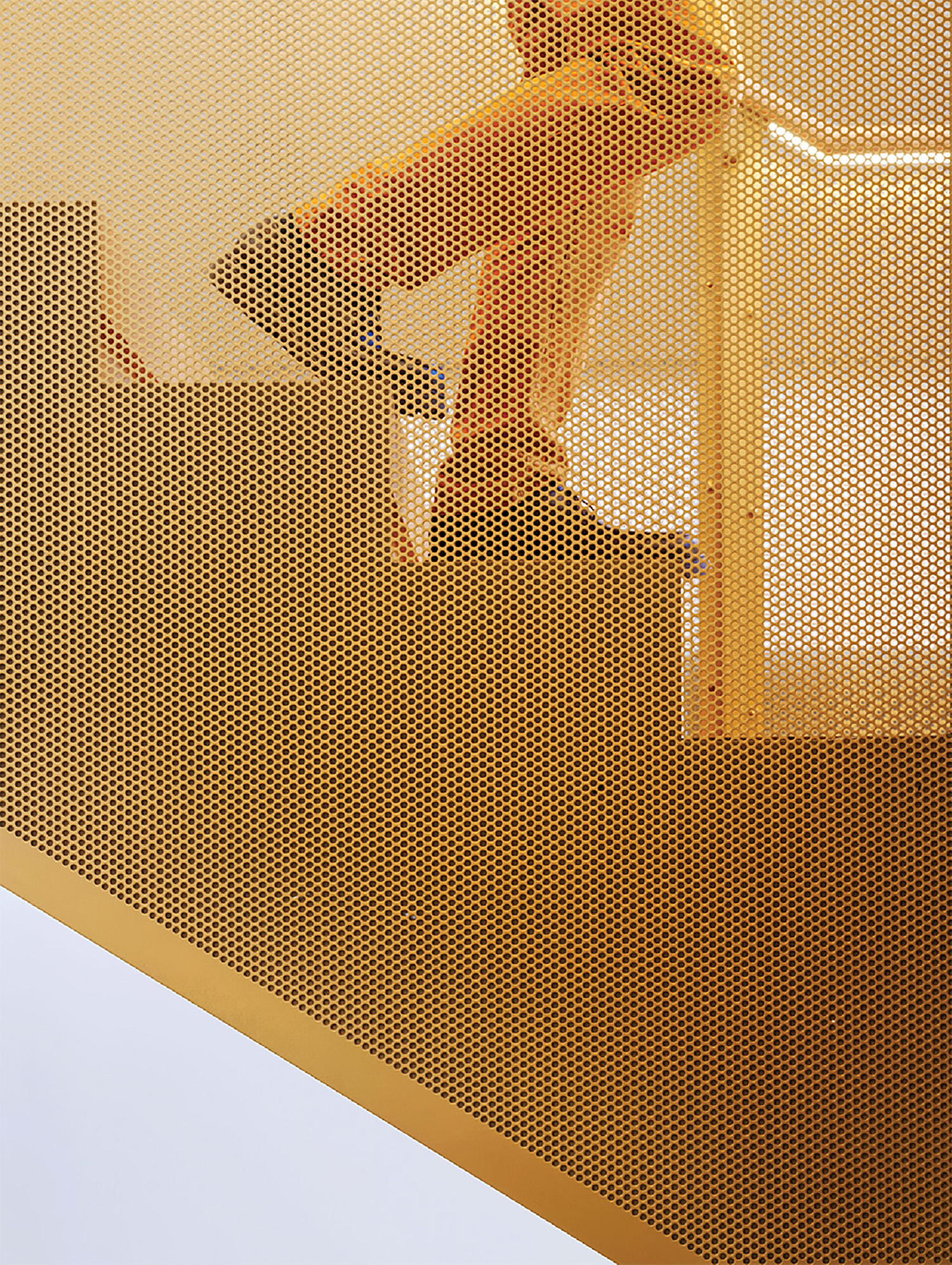 A yellow wall with a white and gold pattern.