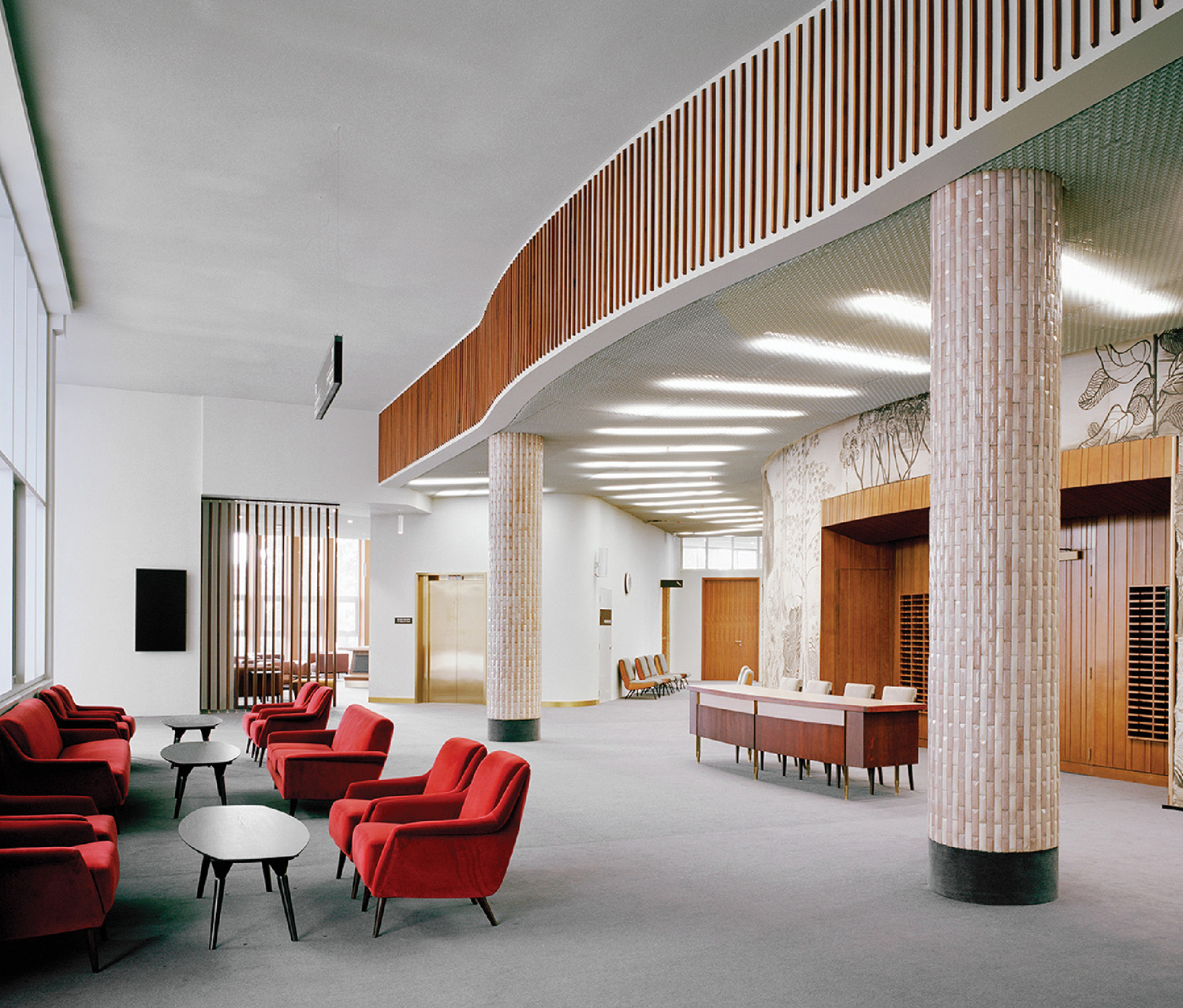 A large room with a lot of red chairs.