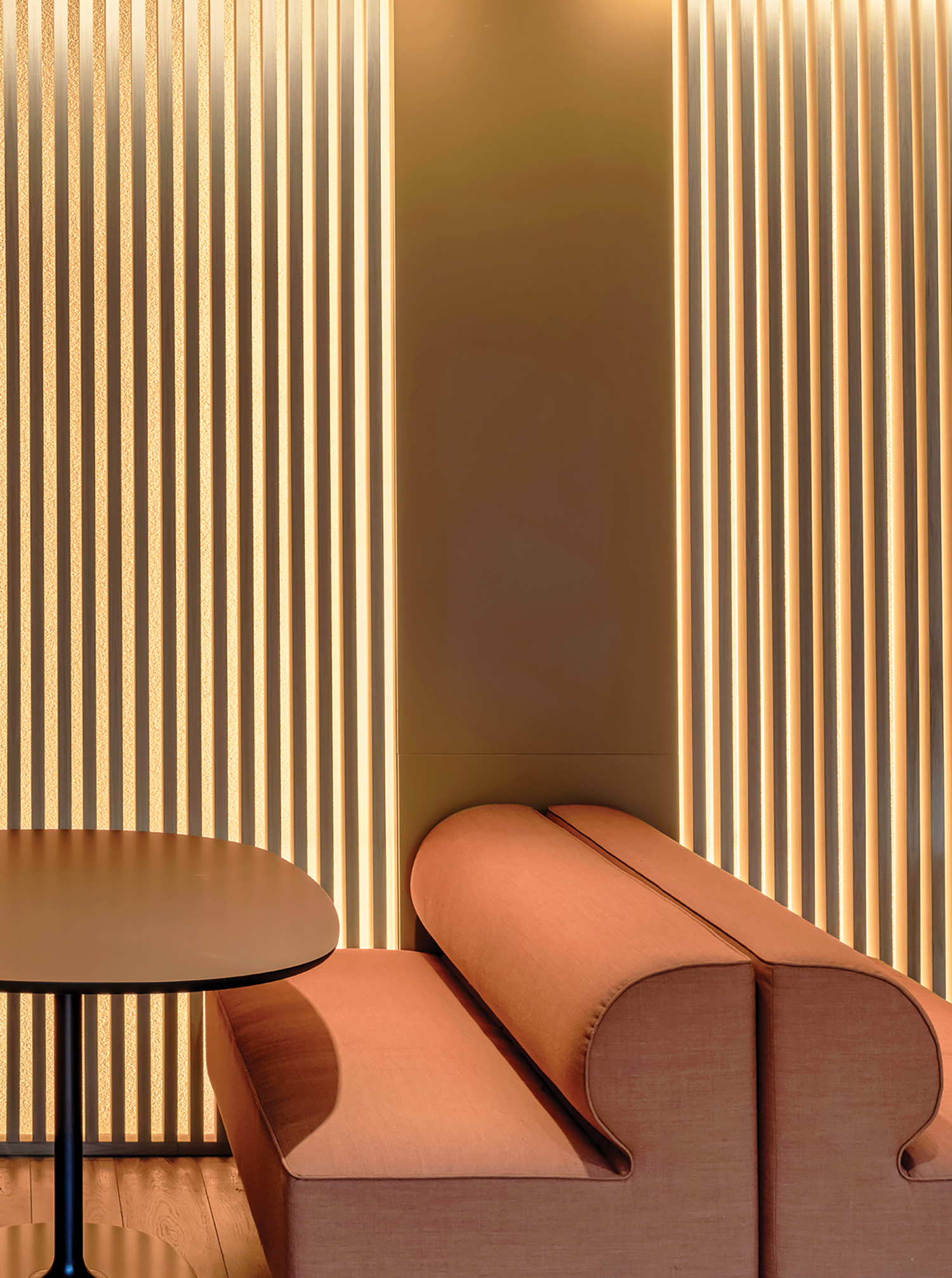 A table and chairs in a room with wooden walls.