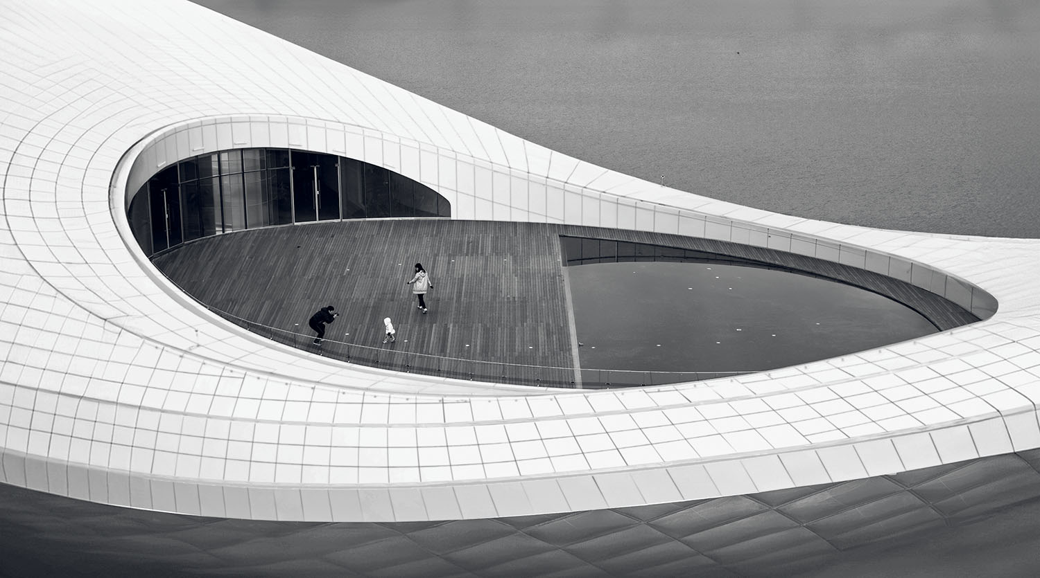 A white building with a circular window.
