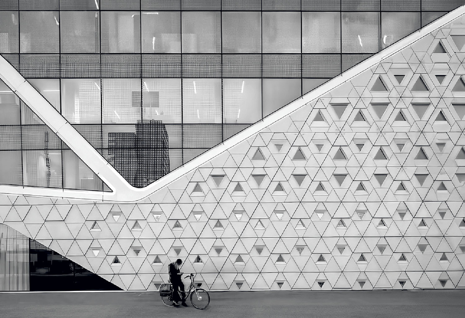 A man is walking in front of a building.