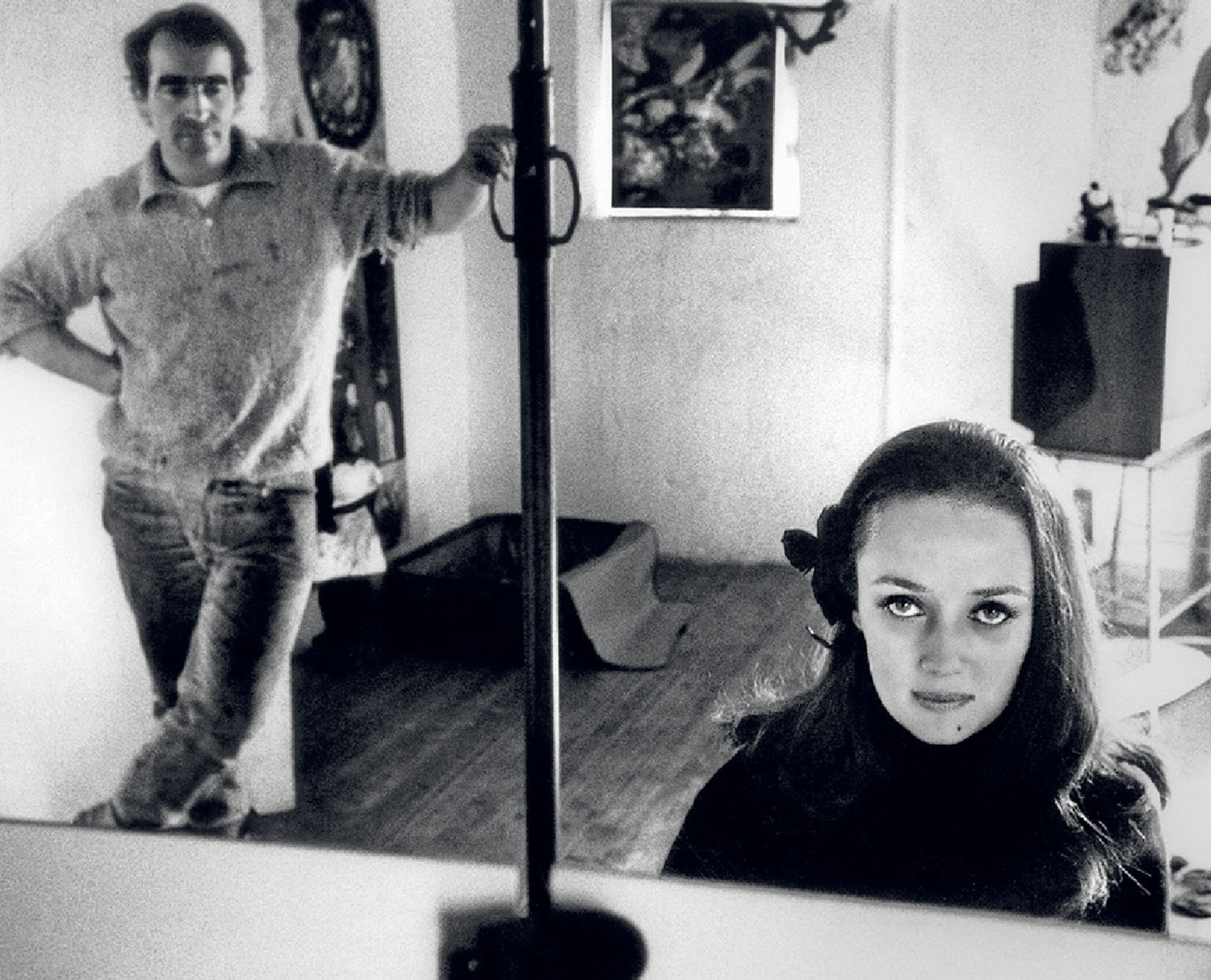 A woman looking at herself in a mirror.