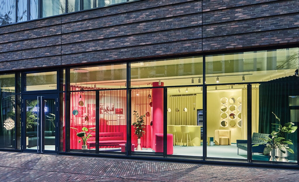 A store window with a red chair and a red chair.