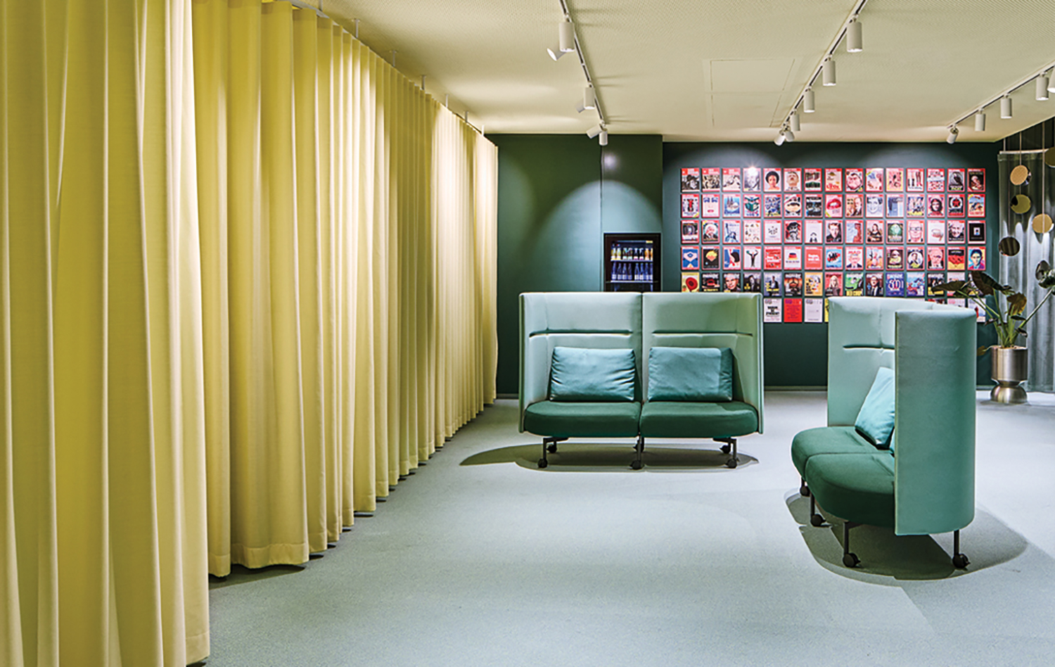 A room with a green couch and a green chair.
