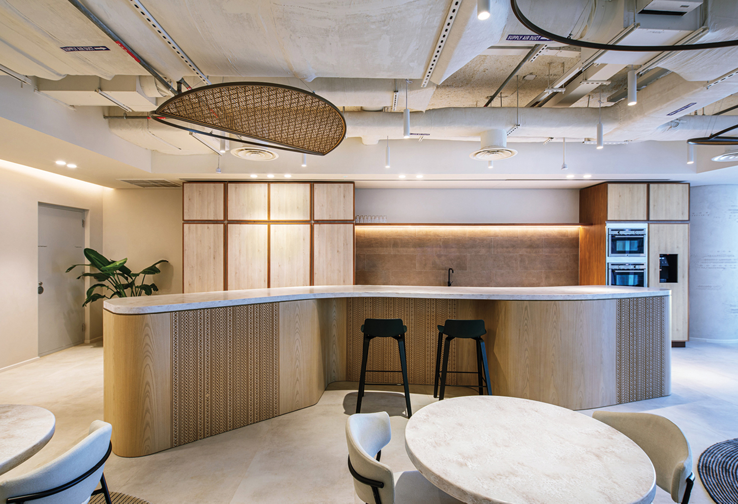 A kitchen with a bar and a table.