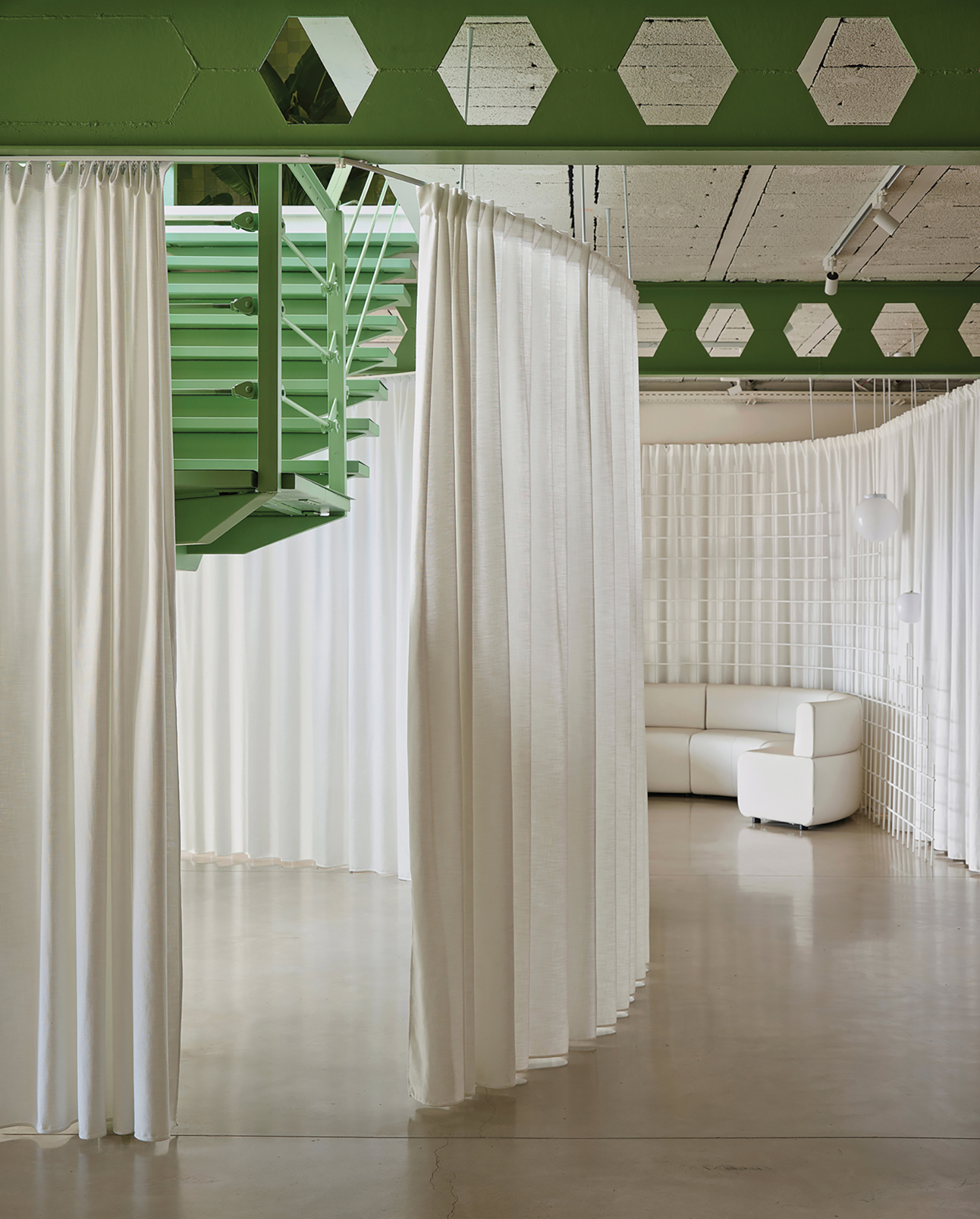 A room with a green ceiling and white curtains.