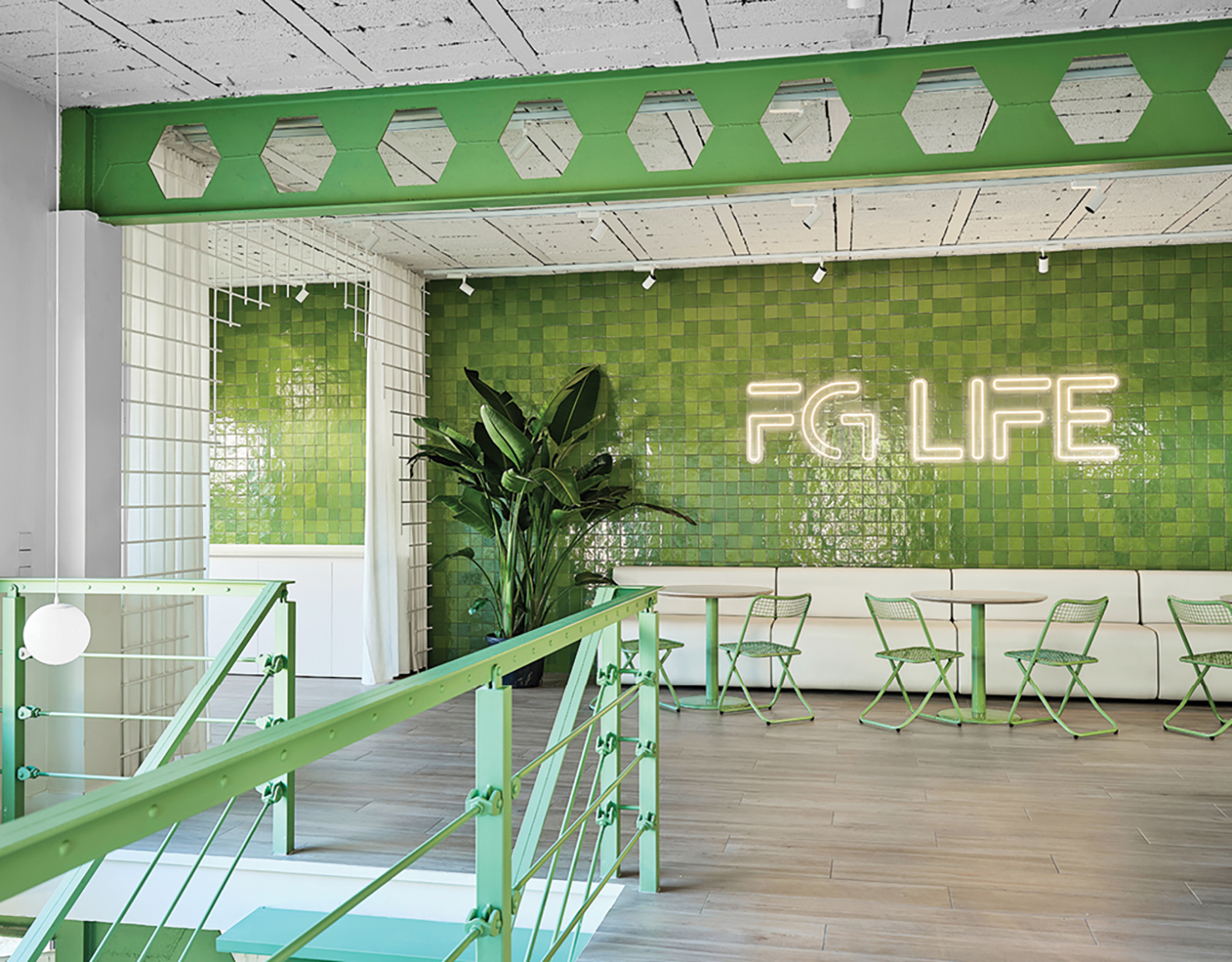A green and white tiled wall.