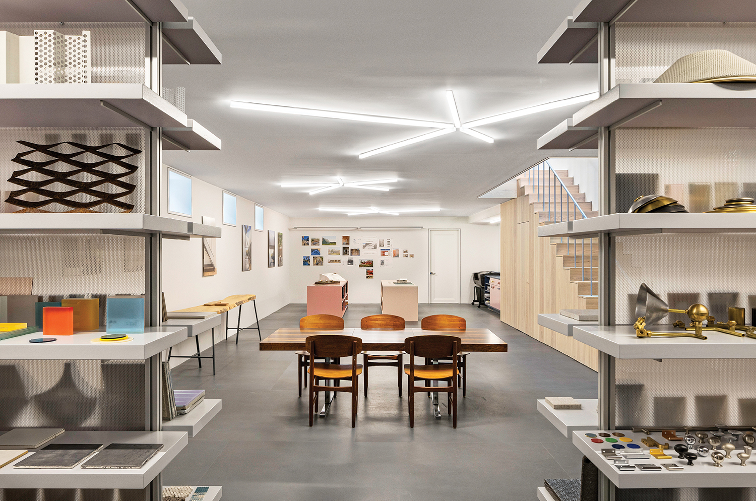 A room with a table and chairs and shelves.