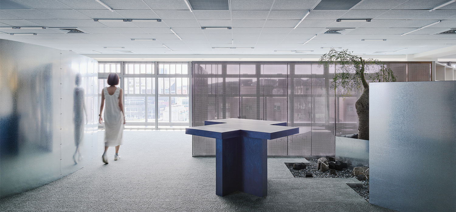a woman walking through a gray office