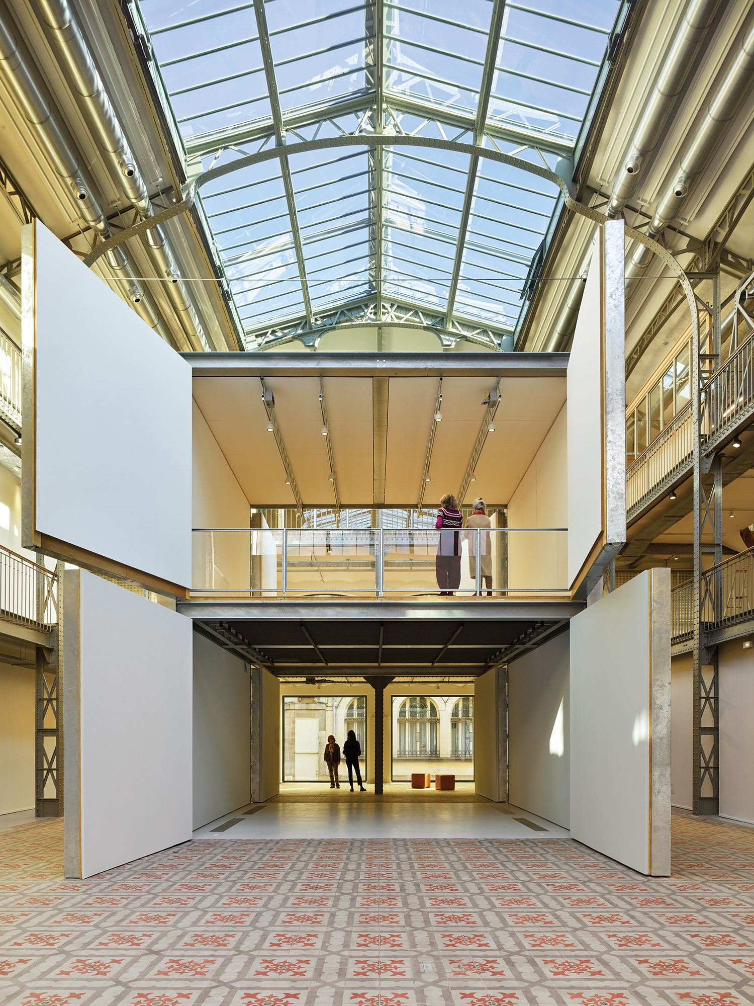 A large room with a skylight and a person walking in it.