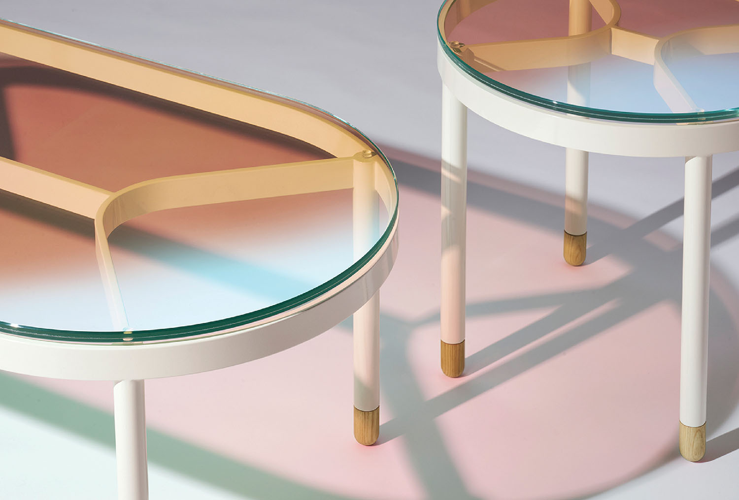 Two tables with a glass top and a wooden base.